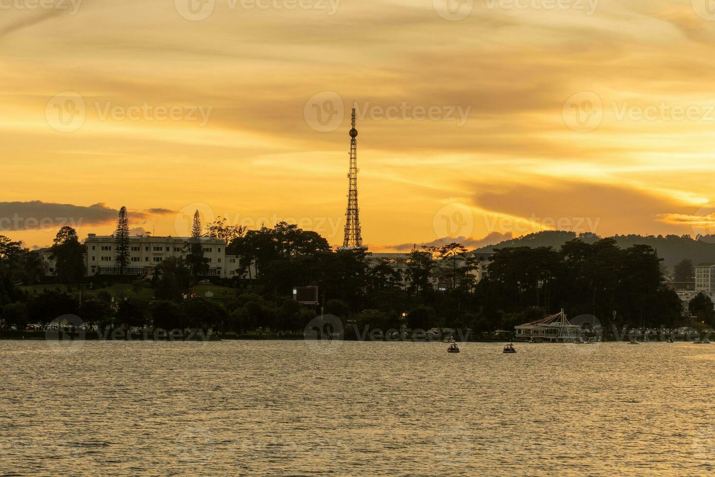 Sunset view of a Da Lat City with development buildings, transportation, market. Tourist city with center square of Da Lat city near Xuan Huong lake photo