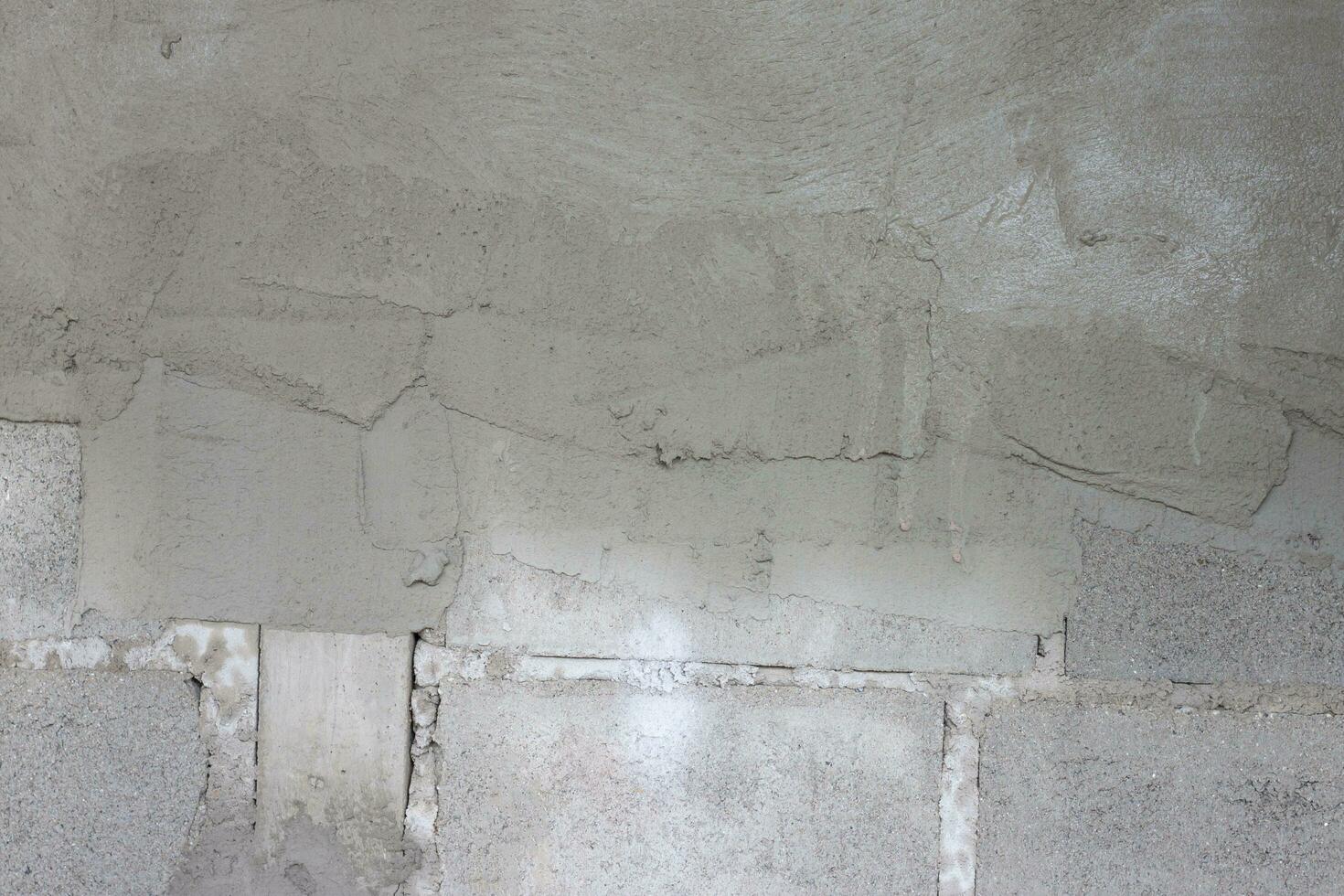 The wall that has just been plastered for half at construction site. photo