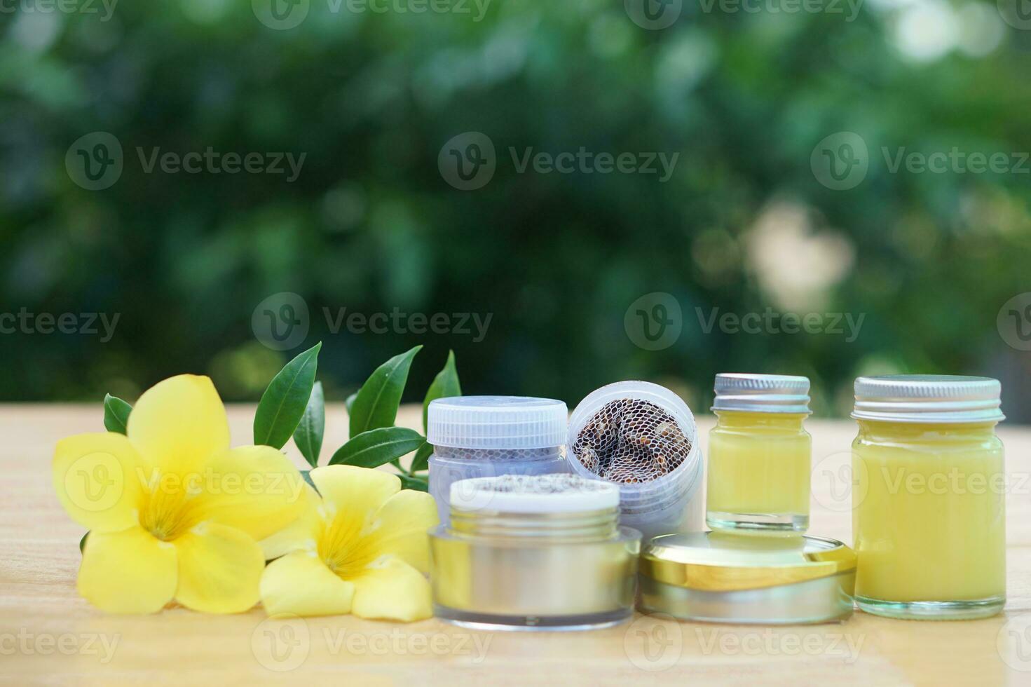 Bottles of homemade Thai herbal ointment and inhaler.Decorated with yellow flower. Concept, Thai local wisdom to use fragrant medicinal herbs to make inhaler and massage balm. photo
