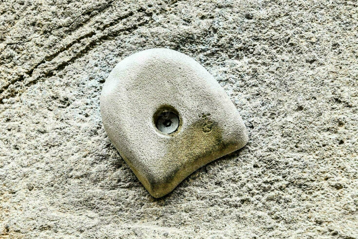 a stone wall with a hole in it photo