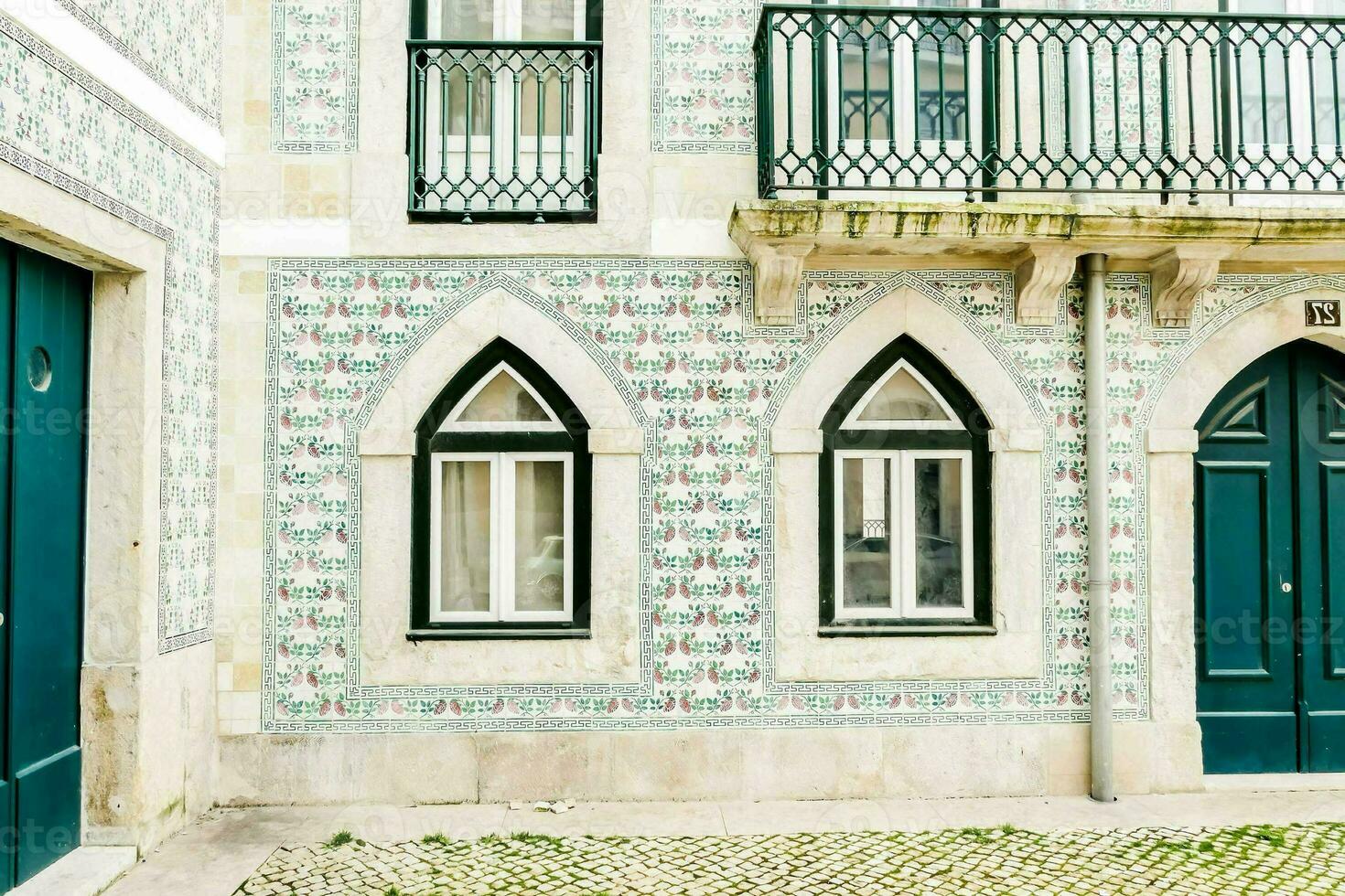 a building with blue and green tiles on the outside photo