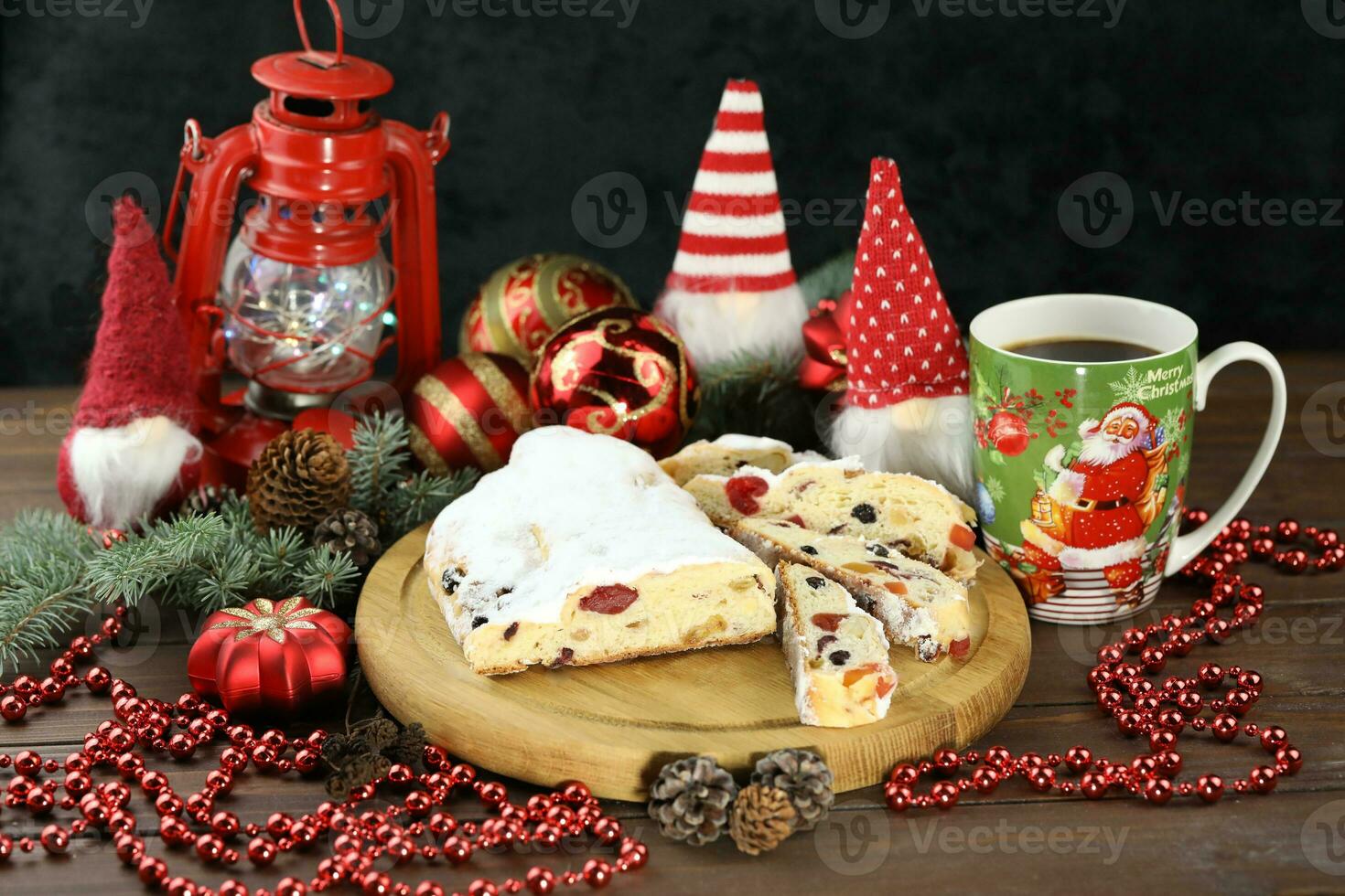 Sliced Chrismas stollen with powdered sugar and christmas decoration photo