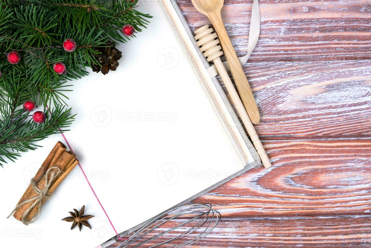 Vintage recipe book and Christmas decor on a wooden table. Holiday baking concept. Flatlay. Top view. Copy space. photo
