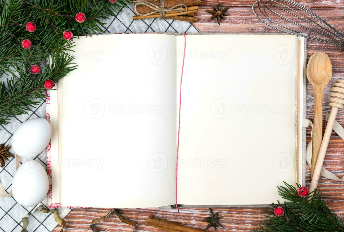 Christmas festive composition with vintage recipe book and Christmas decoration on the table. Christmas baking concept. Flatlay. Top view. Close-up. Copy space. photo