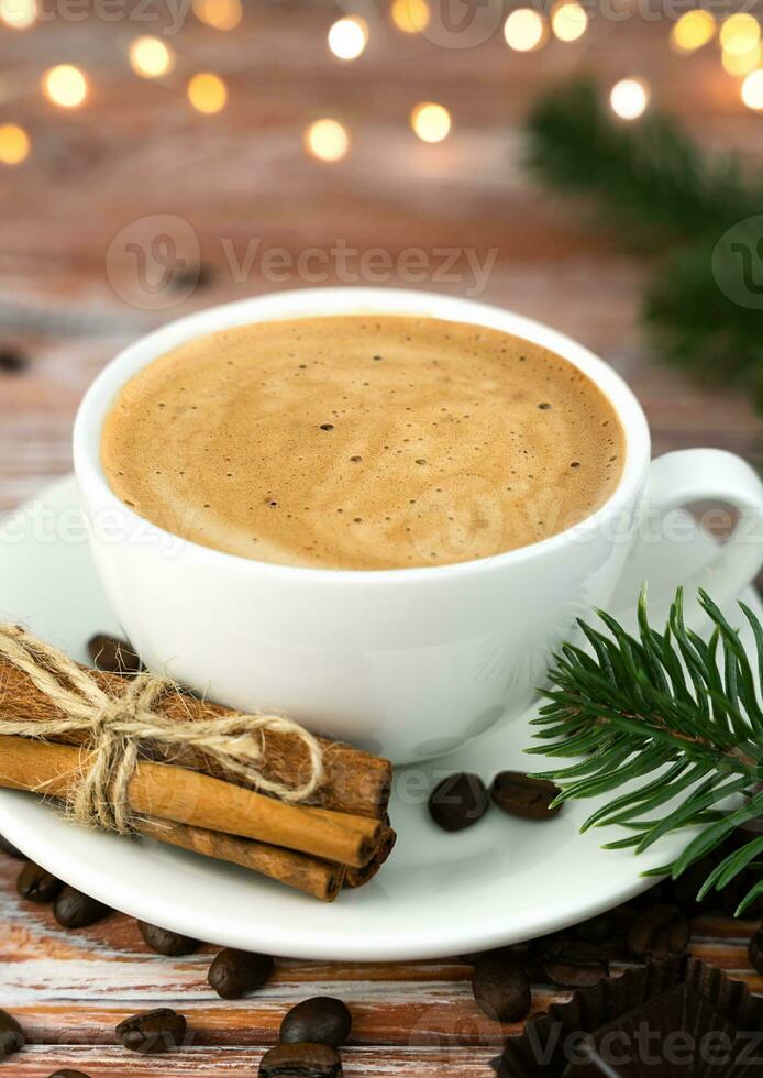 Cup of aromatic coffee with cinnamon on a Christmas table. Christmas morning. Close-up. Copy space. Selective focus. photo