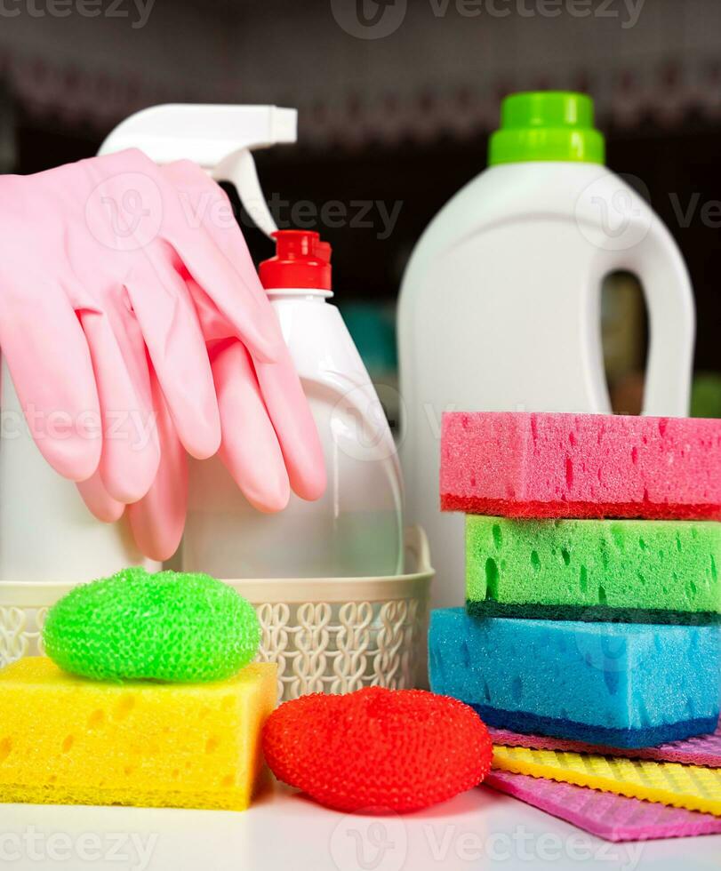 Sponges, rubber gloves and natural detergents and cleaners products in the basket. Cleaning service concept. Annual spring cleaning in the kitchen. Close-up. Selective focus. photo