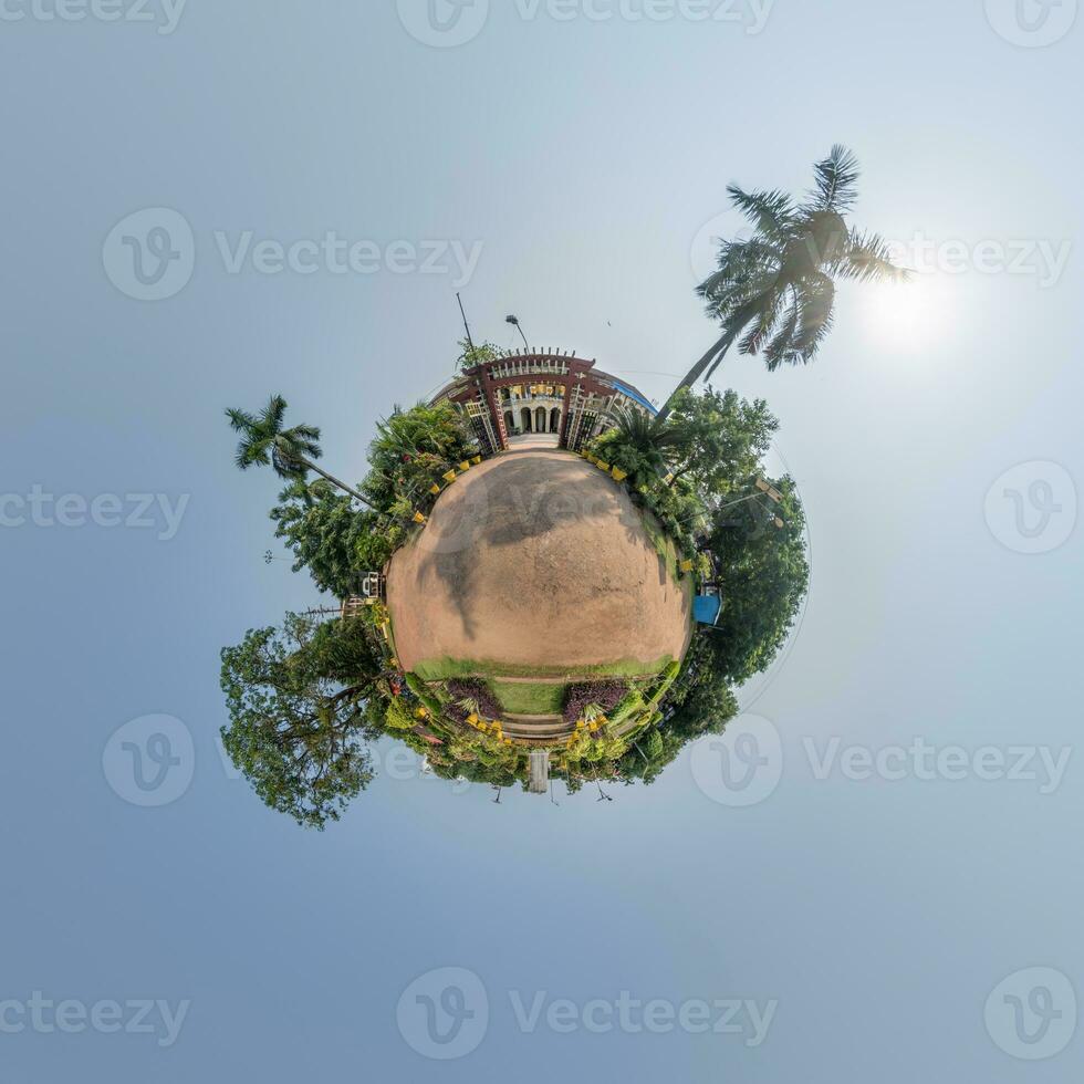 coconut trees in jungle in Indian tropic village on sea shore on little planet in evening sky, transformation of spherical 360 panorama. Spherical abstract view with curvature of space. photo