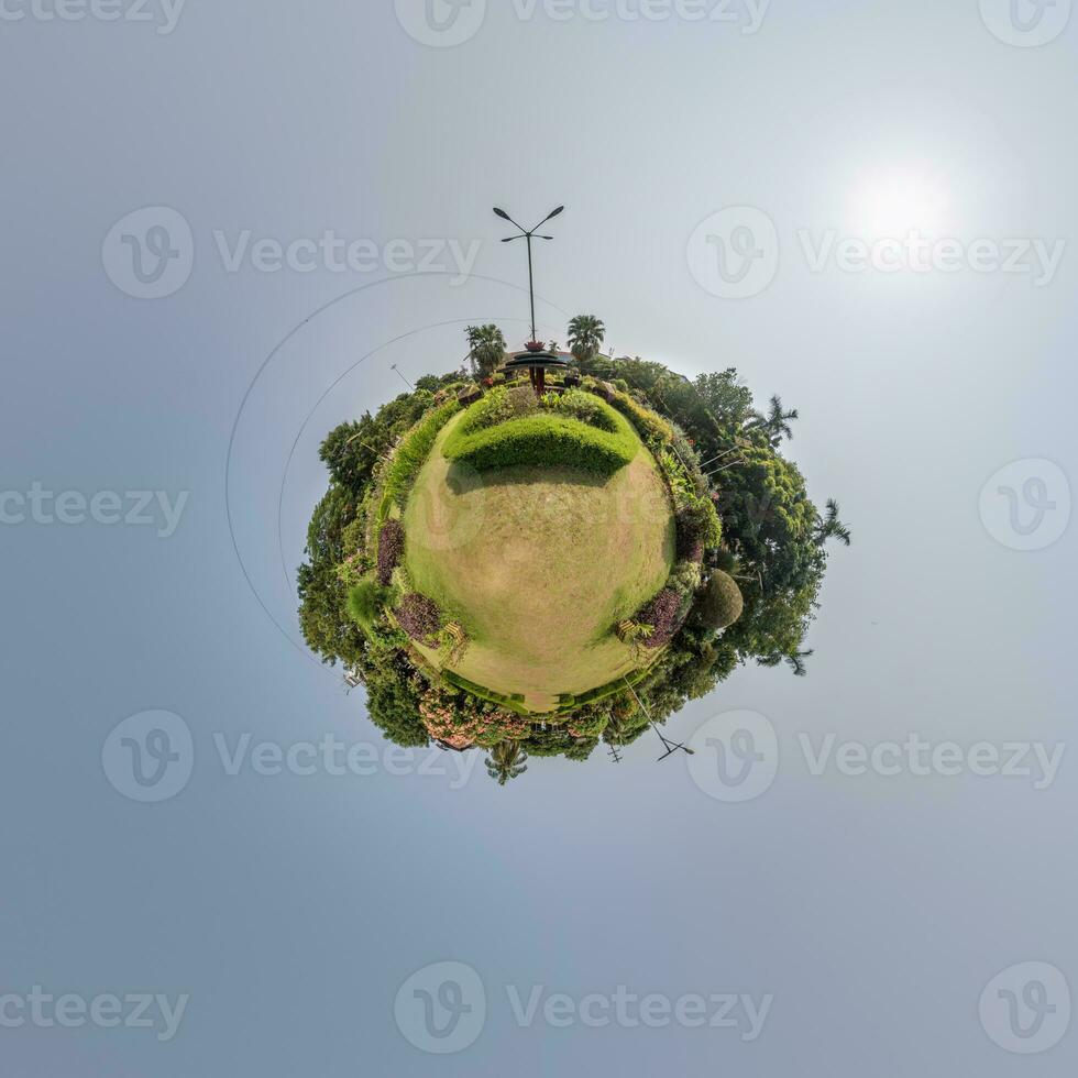 coconut trees in jungle in Indian tropic village on sea shore on little planet in evening sky, transformation of spherical 360 panorama. Spherical abstract view with curvature of space. photo
