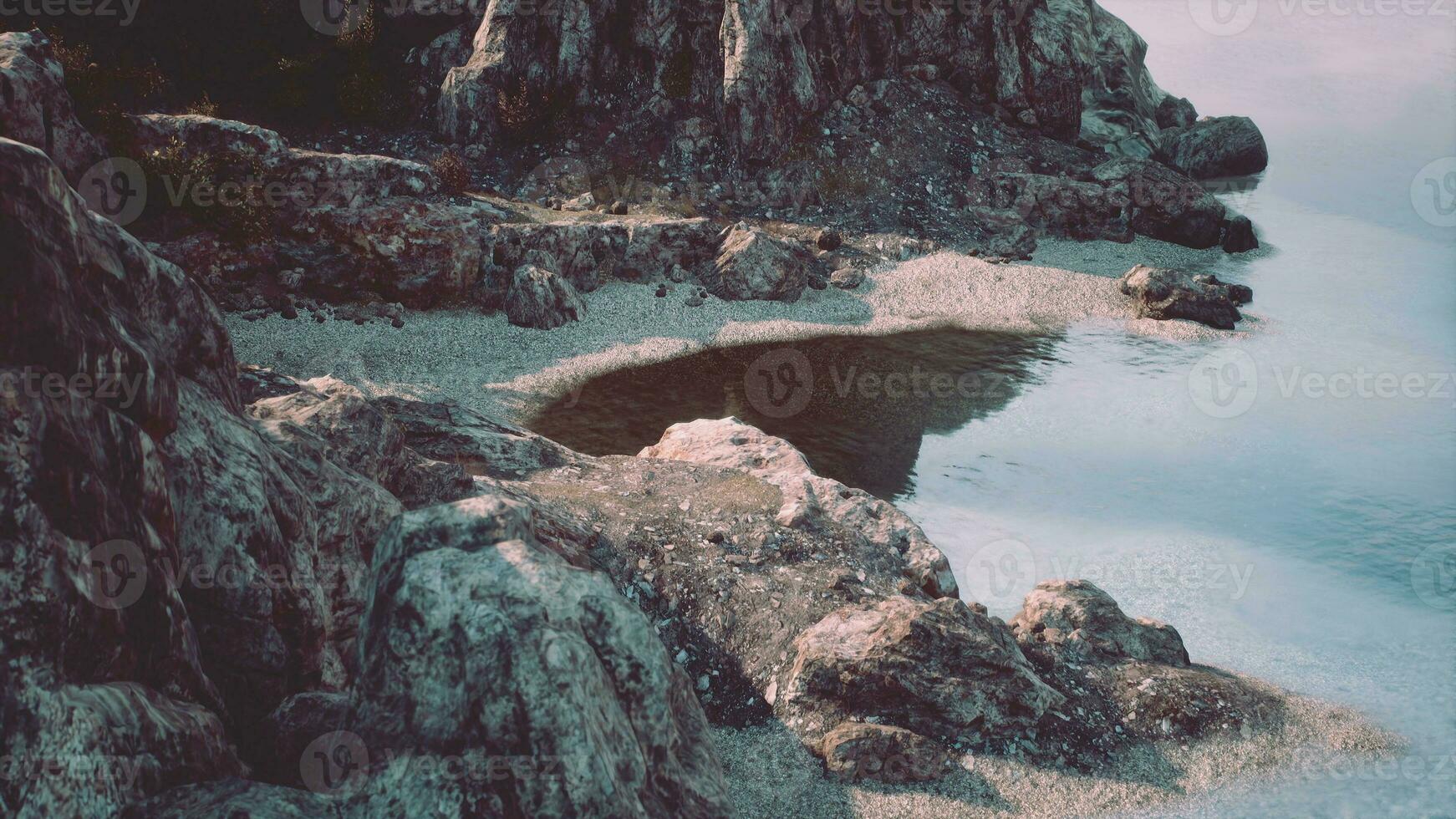 beach and limestone cliffs against azure water photo