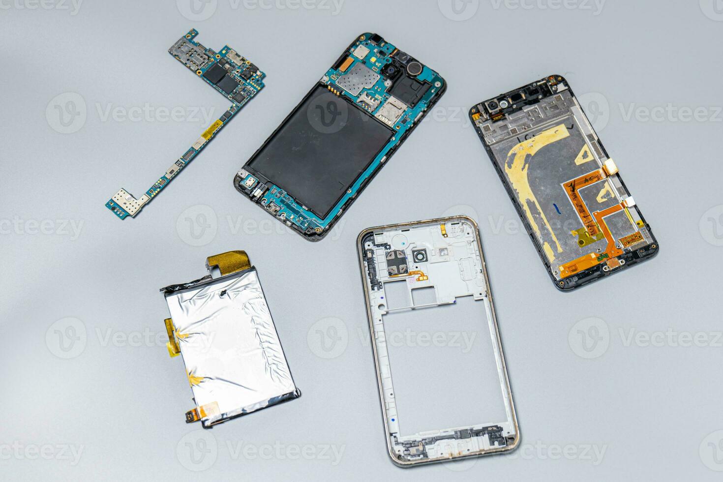 Obsolete old recycle  mobile phone and broken smartphones ,  mobile phone recycling. Recycle e-waste , mainboard old photo