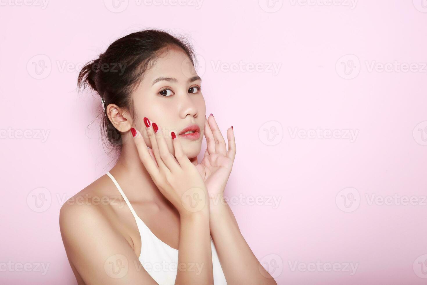 Portrait of beautiful young woman with clean fresh skin on pink background, Face care, Facial treatment. Cosmetology, beauty and spa. Asian women portrait photo