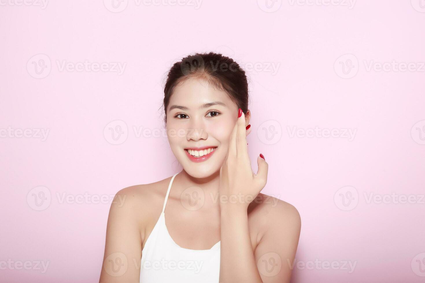 Portrait of beautiful young woman with clean fresh skin on pink background, Face care, Facial treatment. Cosmetology, beauty and spa. Asian women portrait photo