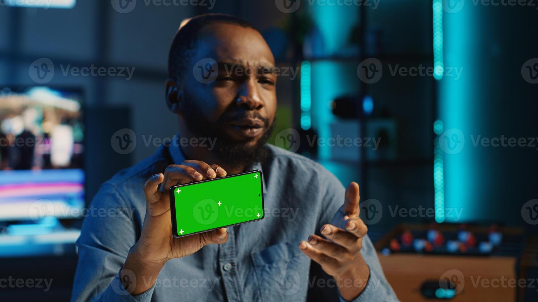 Content creator in studio films newly released chroma key smartphone video review for tech enthusiasts. Viral online star hosts technology internet show, unboxing isolated screen cellphone photo