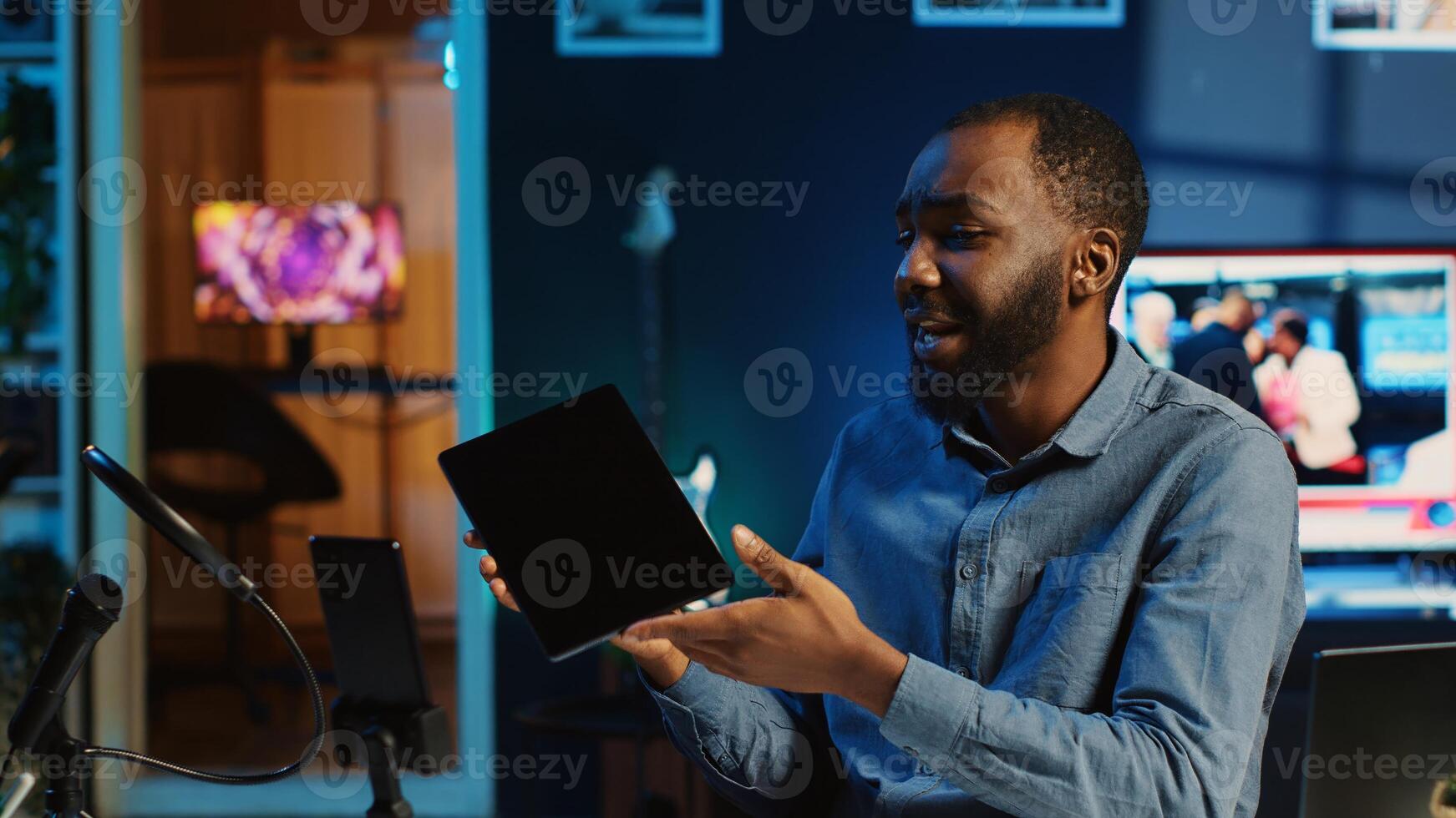 African american technology internet star filming review of newly released graphic tablet, greeting audience and presenting them feedback about touchscreen sensitivity, doing endorsement photo