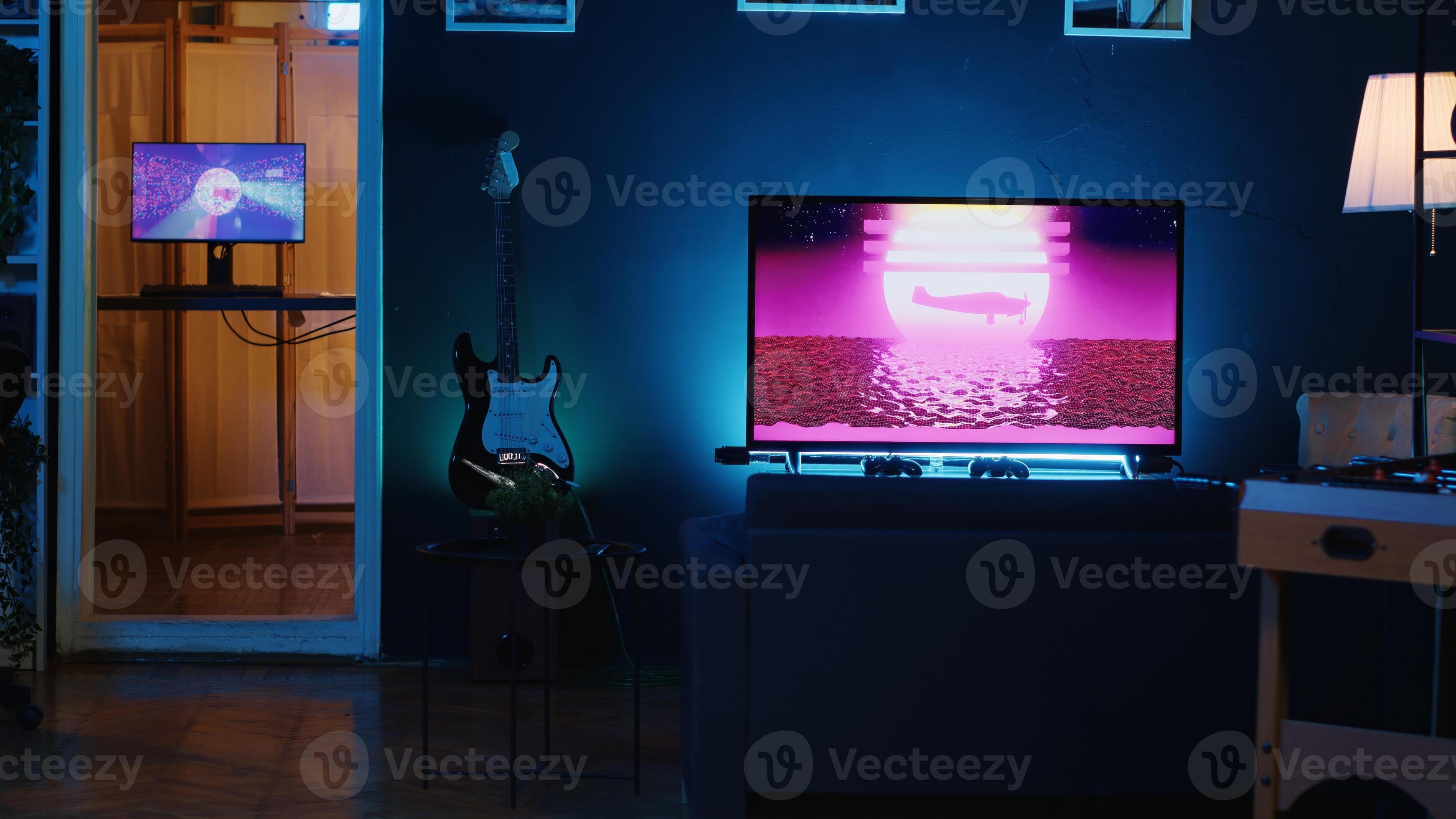 Empty personal studio illuminated with RGB lights used for internet video production. Dimly lit living room filled with interior home decor and 3D animations running in background 35012269 Stock Photo...
