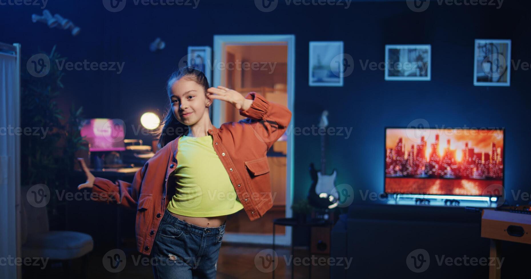 Young girl getting tons of engagement on her dancing clips posts on social network platforms. Happy internet star child filming viral videos, impressing audiences with dance moves photo