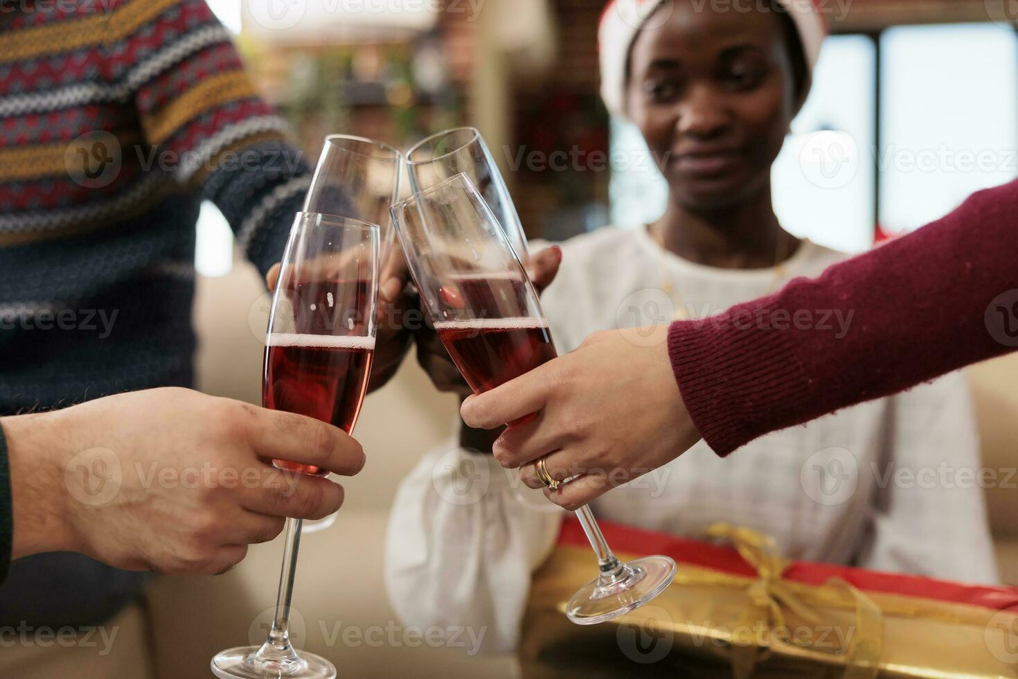 Diverse colleagues toasting and clinking glasses filled with sparkling wine, celebrating christmas together. Employees drinking alcohol and saying cheers on new year holiday in office photo