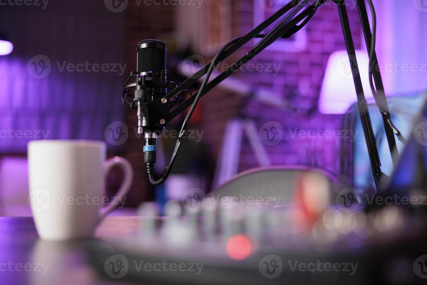 Close up shot of specialised radio equipment used in home personal studio by dj to produce music and record internet show. Empty living room with rgb lights and entertainment gadgets photo
