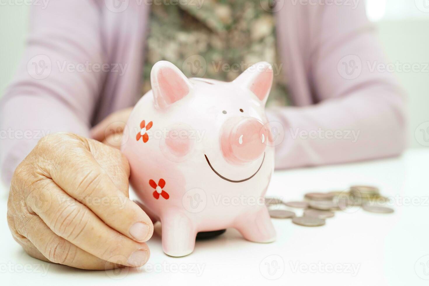 Retired elderly woman counting coins money with piggy bank and worry about monthly expenses and treatment fee payment. photo