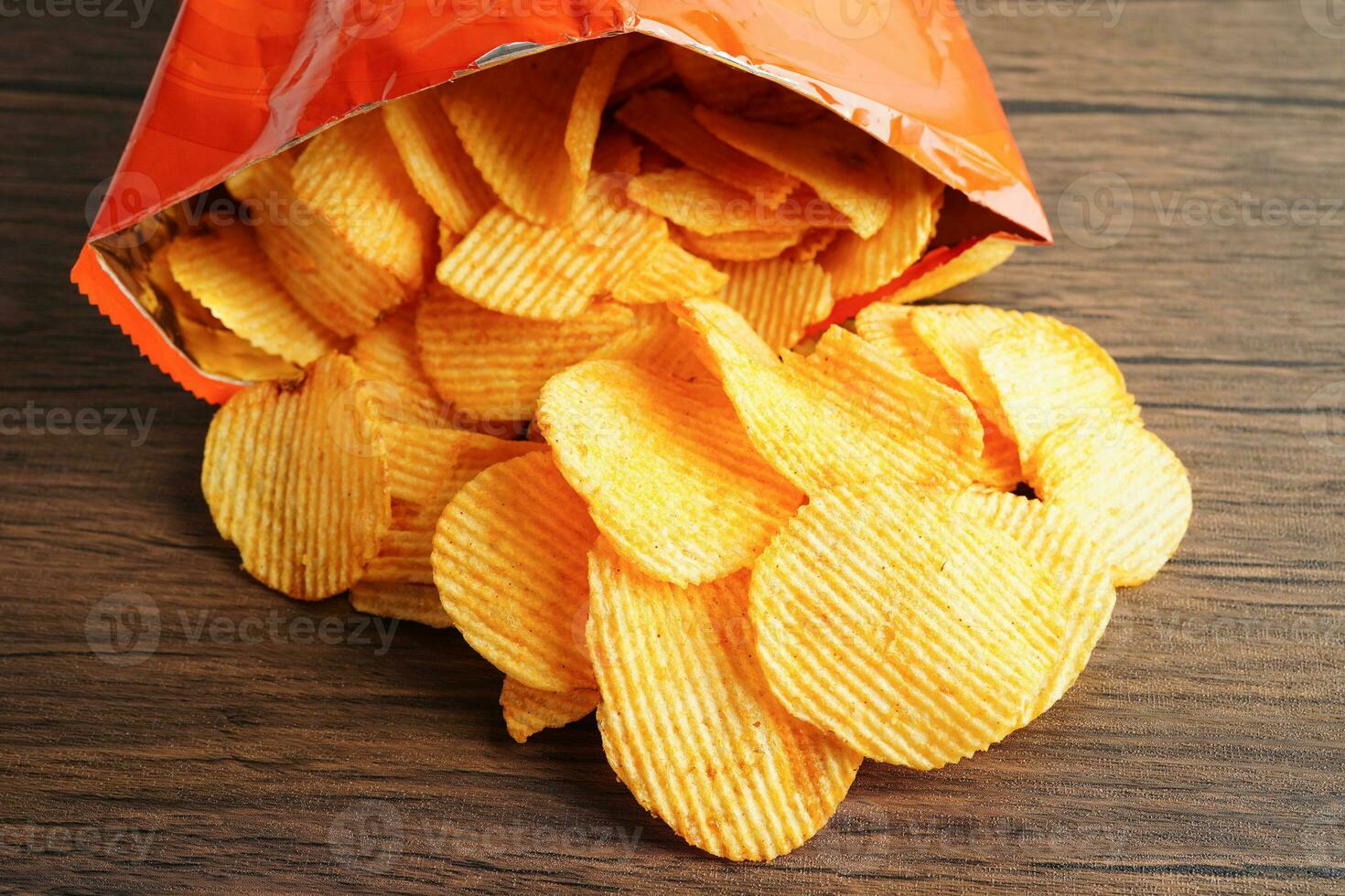 Potato chips in open bag, delicious BBQ seasoning spicy for crips, thin slice deep fried snack fast food. photo