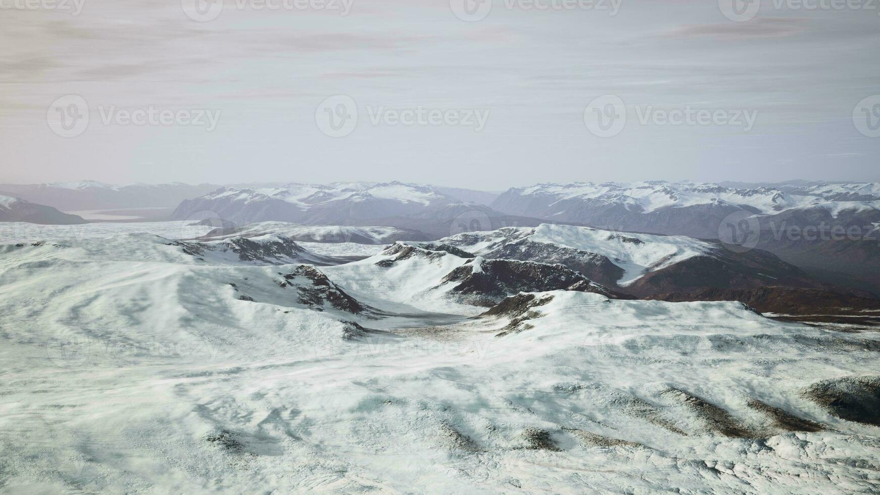 large snow patch left over on the volcanic rock field of a mountain in summer photo