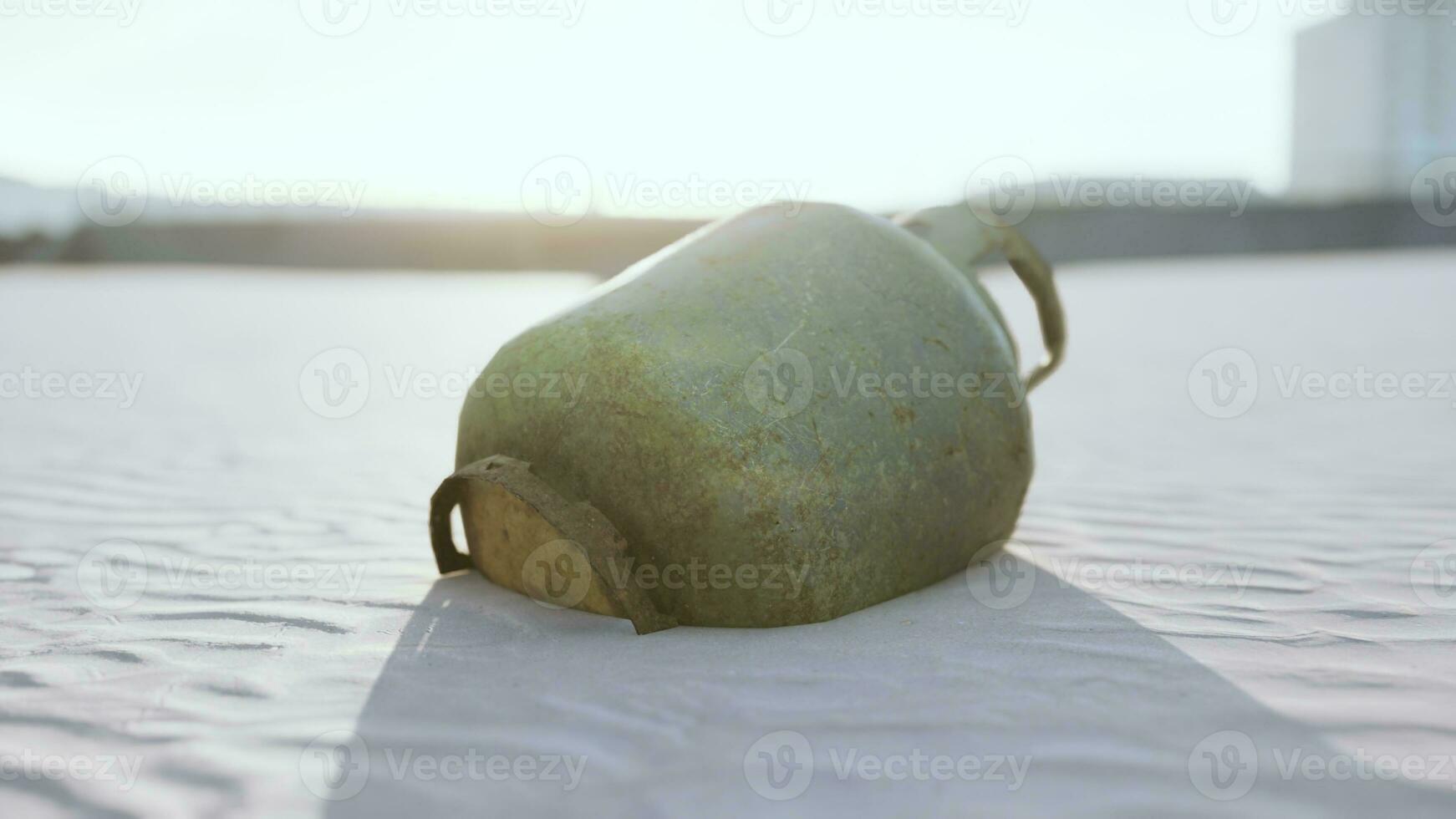 old rusted metal gas tank on the beach photo