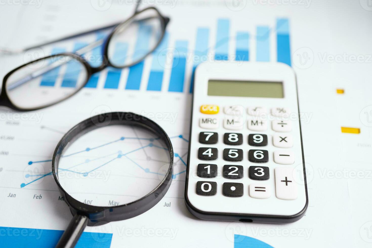 Magnifying glass on charts graphs paper. Financial development, Banking Account, Statistics, Investment Analytic research data economy. photo