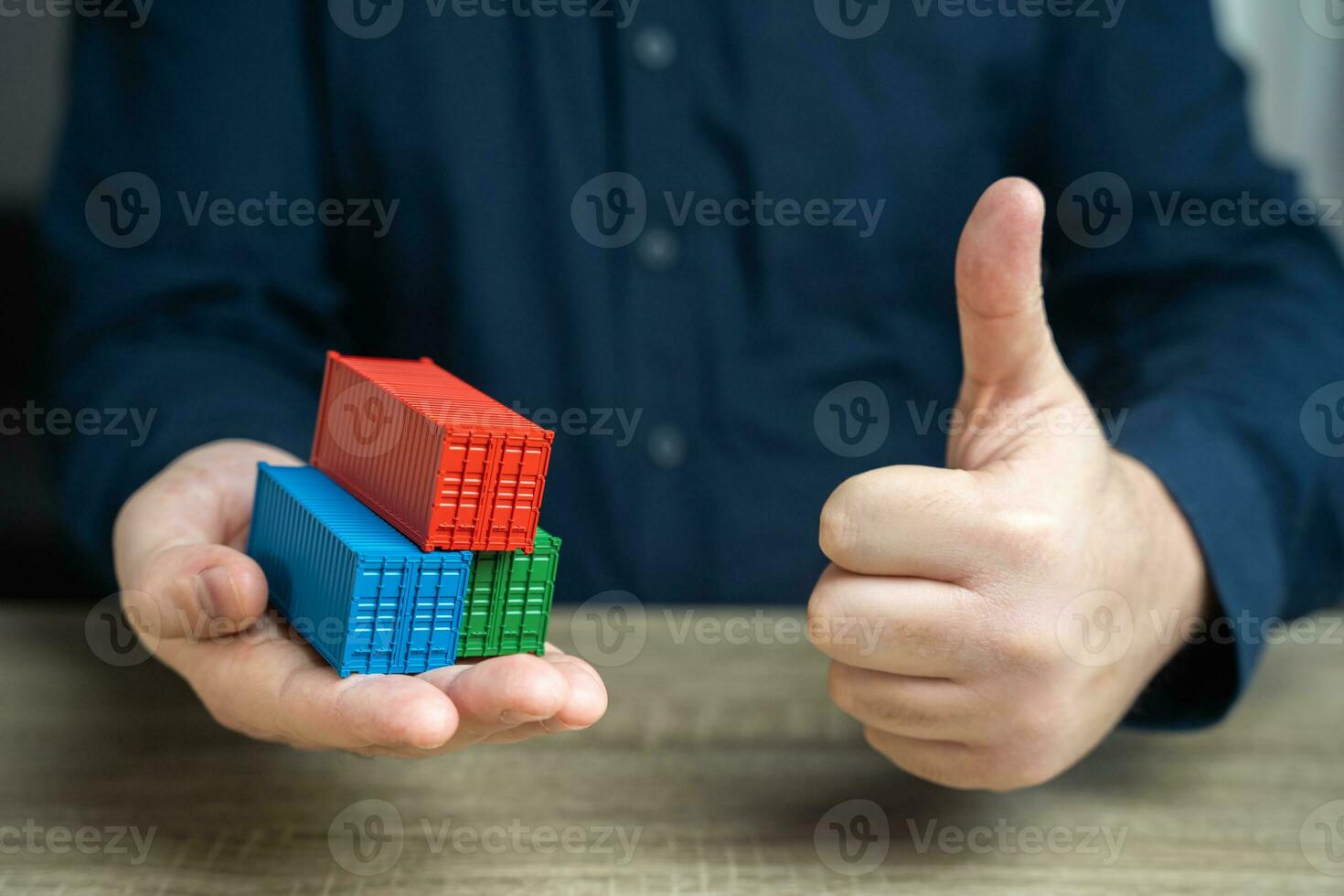 Shipping containers and a thumbs up gesture seal of approval. Conclude a trade agreement. Achieve success in signing a contract for the sale of goods. High rates of cargo transportation volumes photo