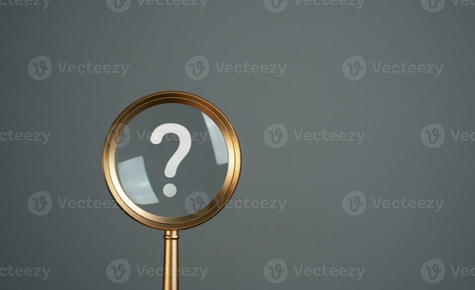 Magnifying glass and question mark. Curiosity, inquiry, uncertainty. Search for answers, clarity, and understanding. Solving mysteries, uncovering hidden truths. Quest for knowledge or solutions. photo