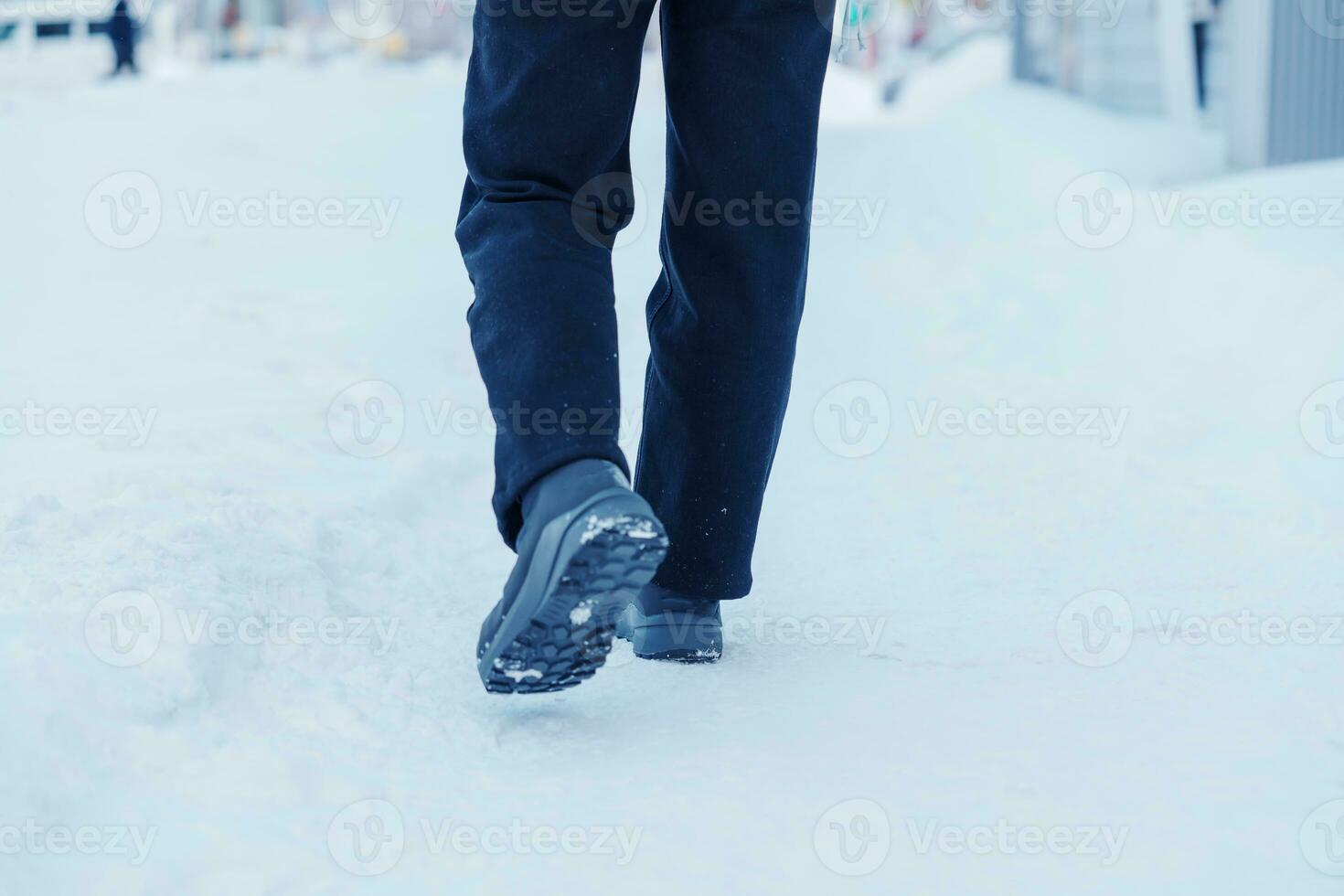 traveler walking on the snow,  closeup waterproof boots or shoes during hiking on snowy forest. Winter season photo