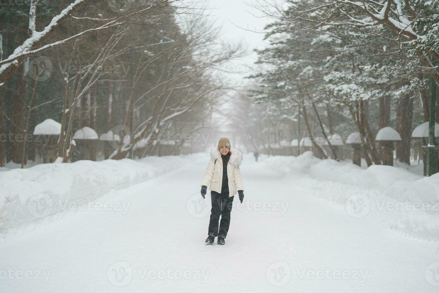 happy Traveler with Sweater and backpack walking on snow covered forest in frosty weather. Winter Travel, Adventure, Exploring and Vacation concept photo