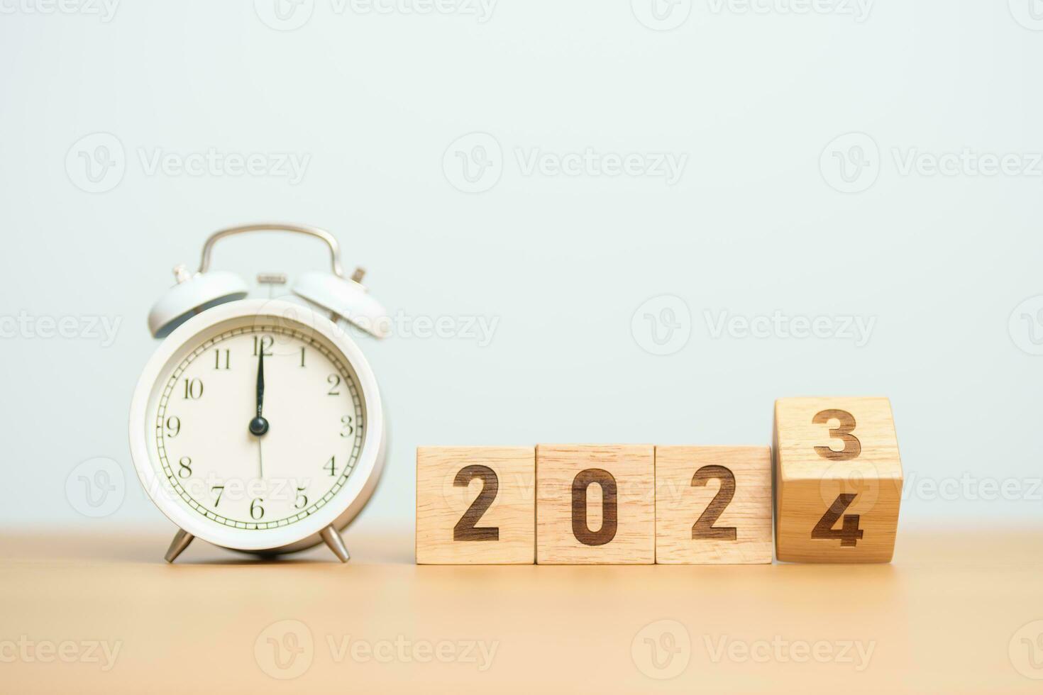 Happy New Year with vintage alarm clock and flipping 2023 change to 2024 block. Christmas, New Start, Resolution, countdown, Goals, Plan, Action and Motivation Concept photo