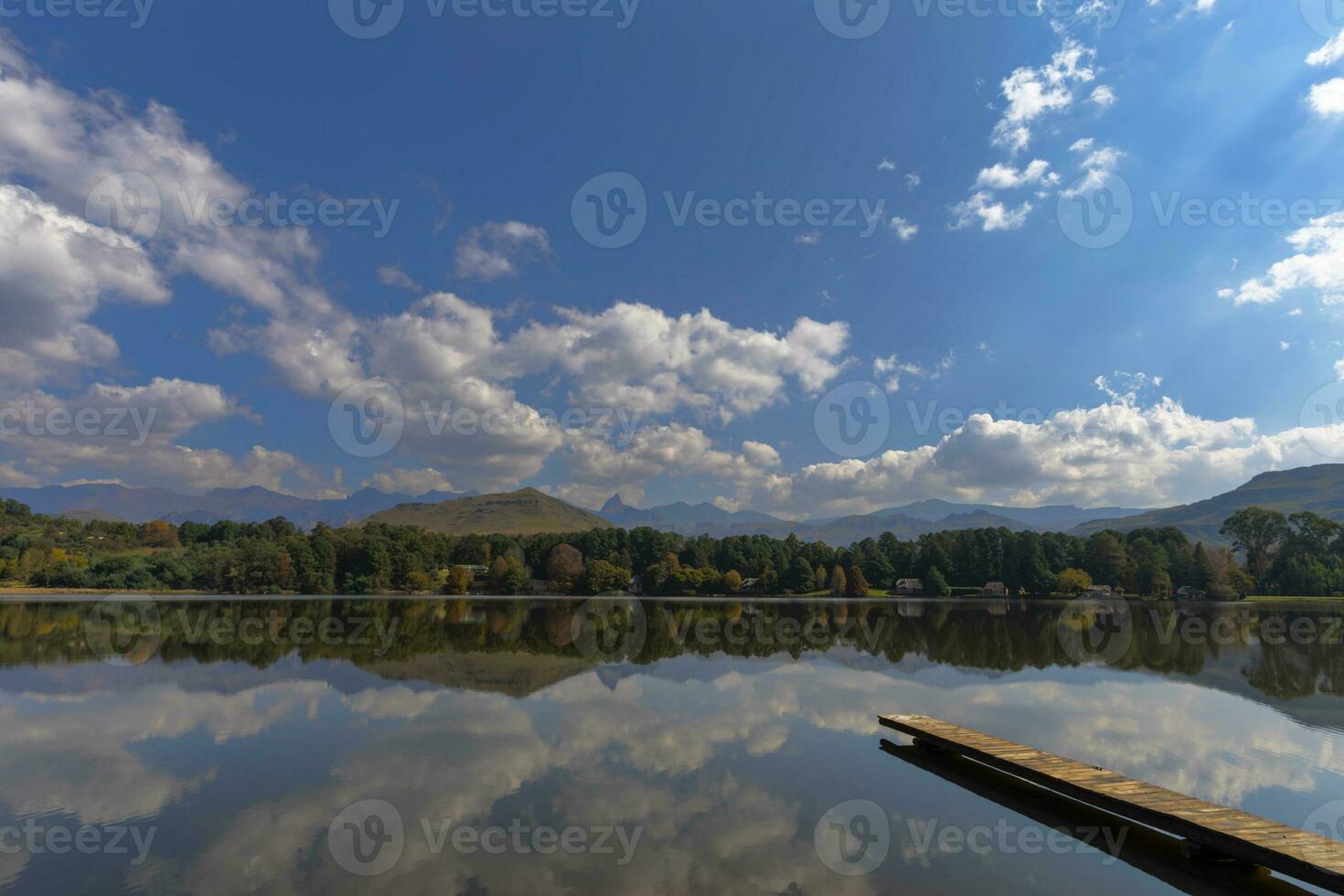 Reflection of autumn colors and clouds on the lake photo