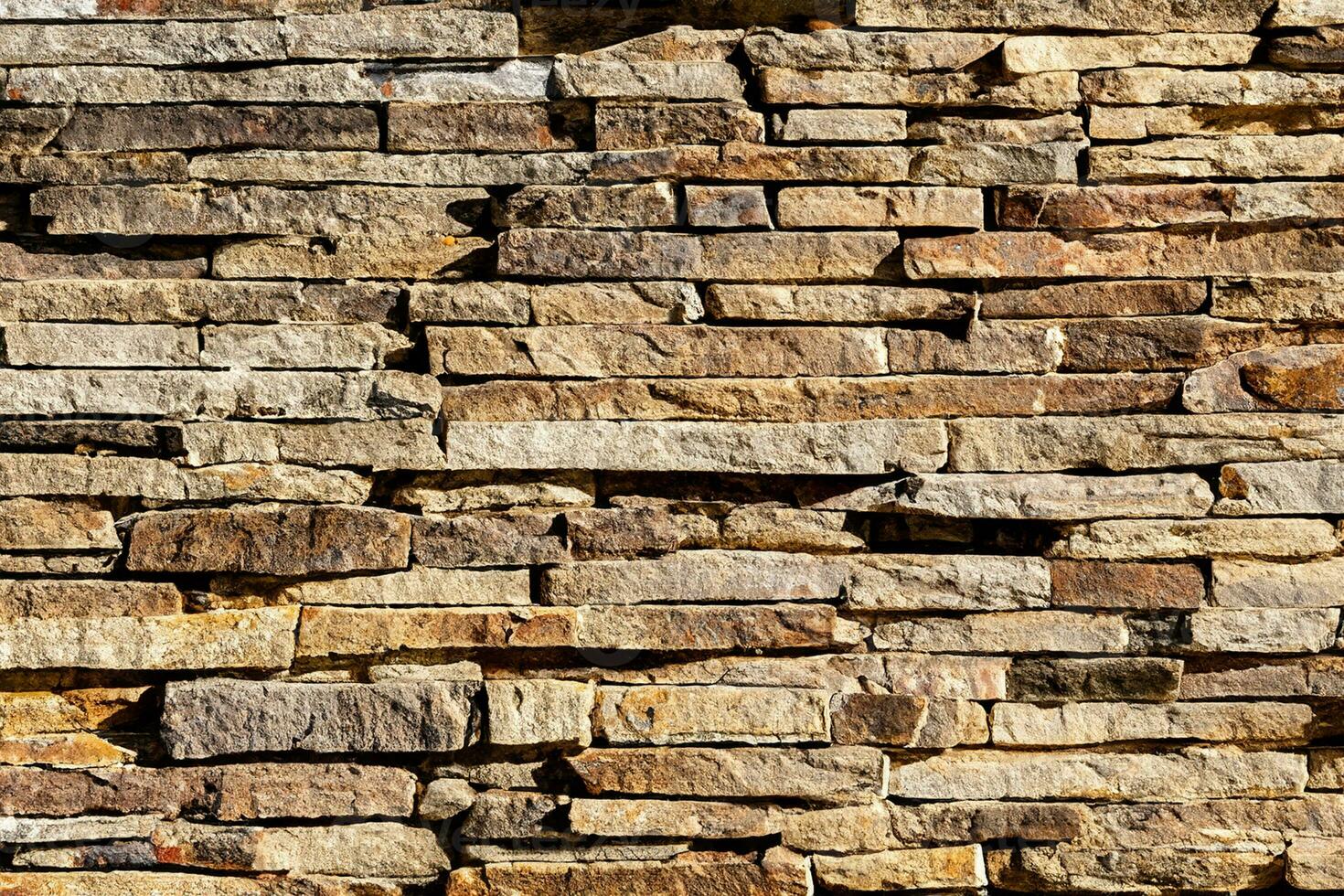 Background of stone wall texture. The surface of the stones is brown photo