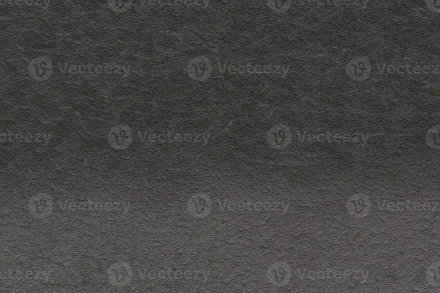 Dark gray background from natural slate. Texture of stone closeup. Graphite background macro photo