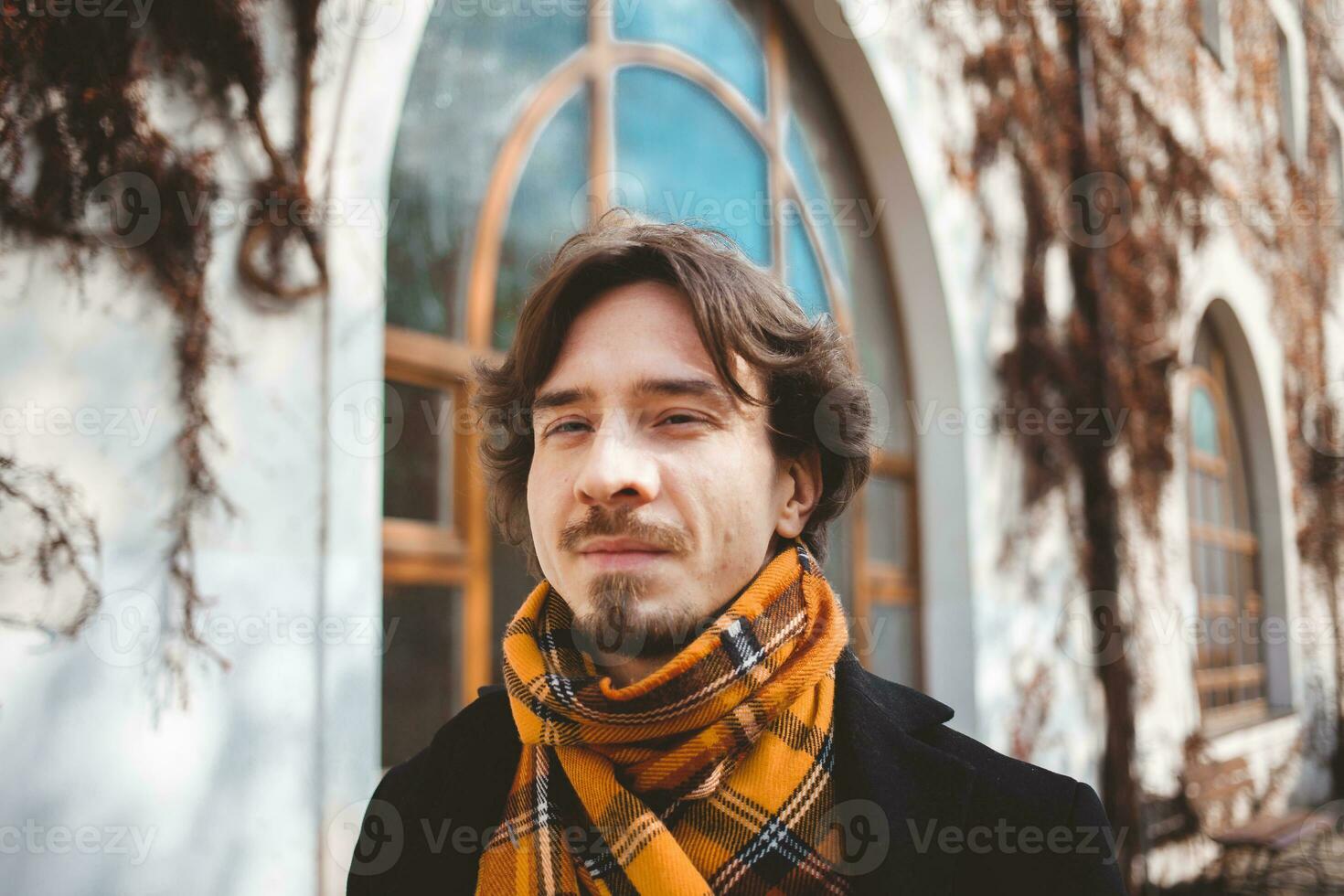 man walking around Prague, beautiful portrait, stylish traveler. looking at camera photo