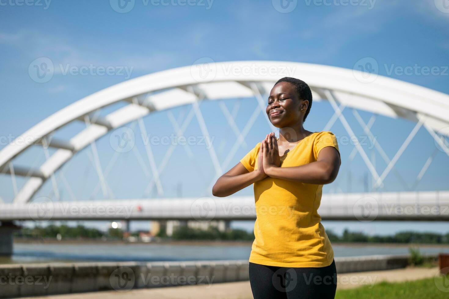 Young  sporty woman enjoys meditating outdoor photo