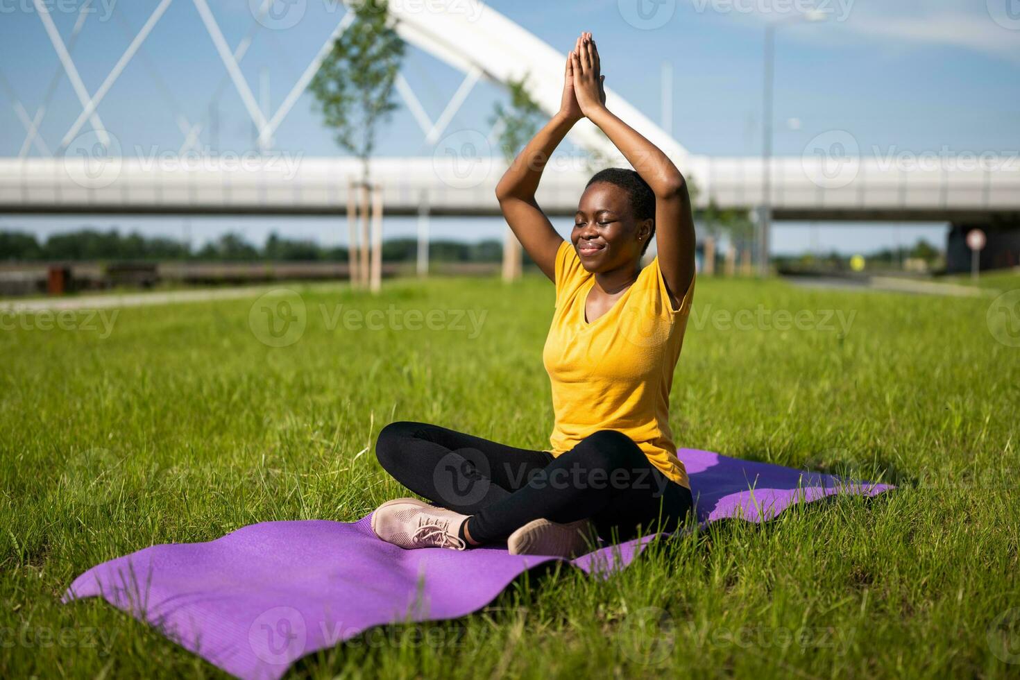 Young woman enjoys meditating outdoor photo