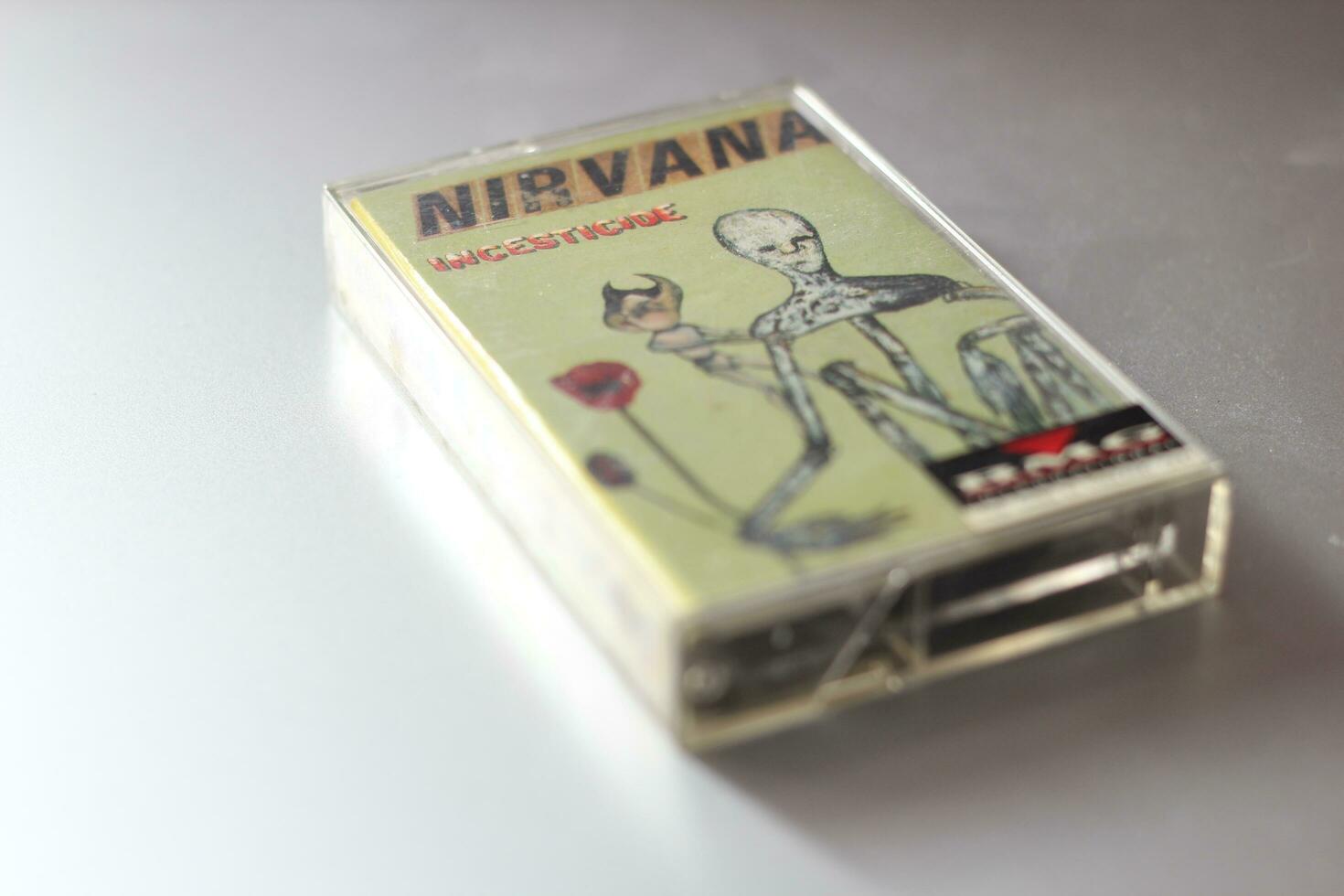 Bangkok, Thailand - 22 January 2022  Nirvana Album Incesticide's 90s cassette tape on gray background. photo