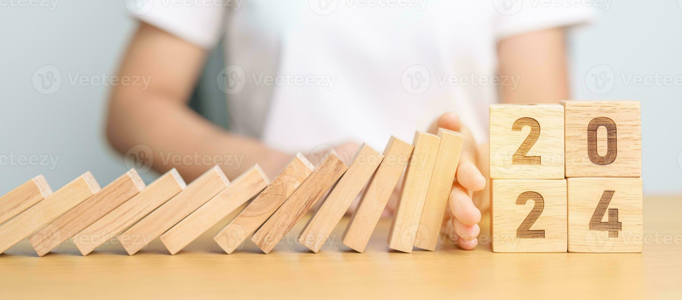 2024 year with falling blocks on table, Risk Management, recession, business financial, Resolution, strategy, goal, New Year planning and inflation economy concepts photo