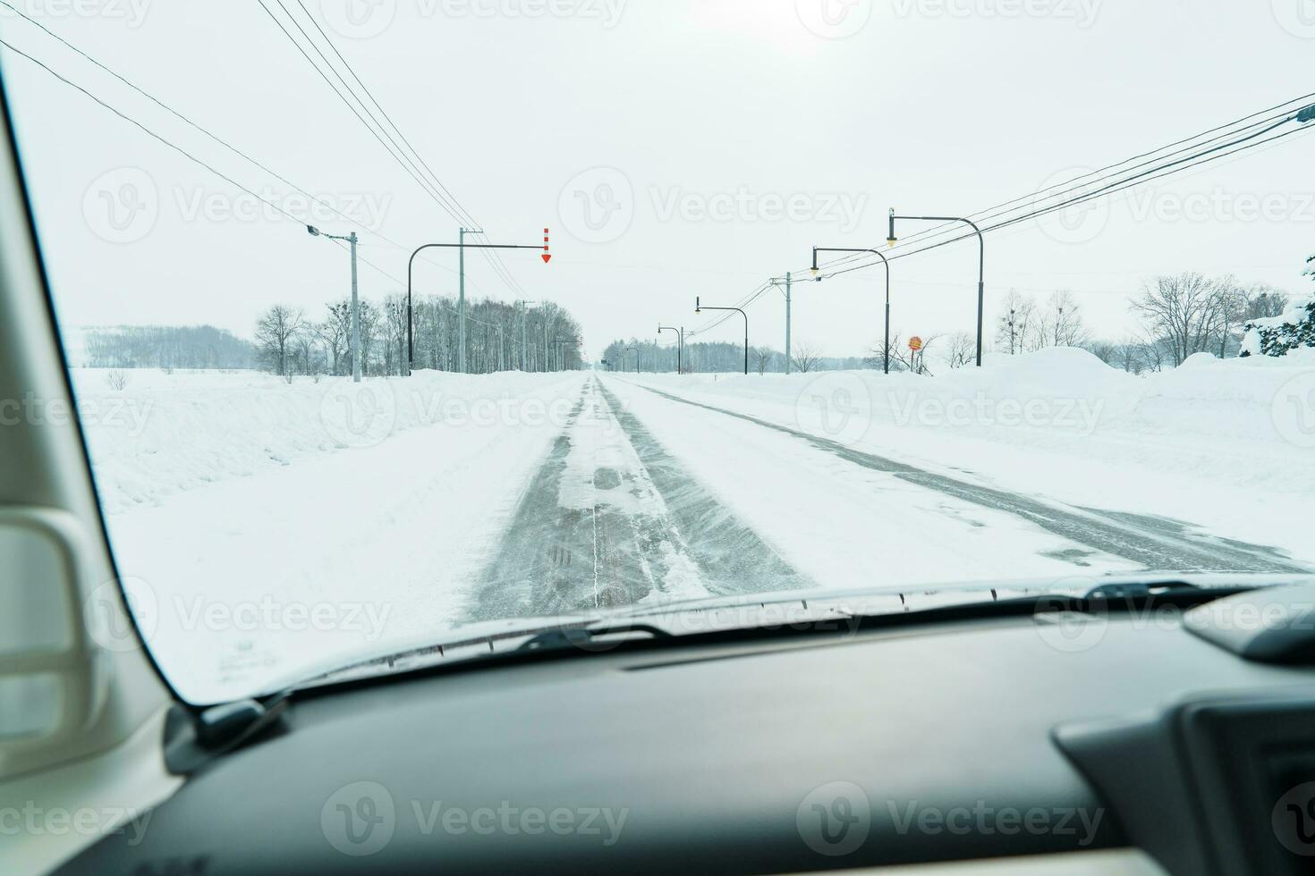 Beautiful snow road forest view during car driving in winter season. Winter travel, Road trip, Adventure, Exploring and Vacation concepts photo