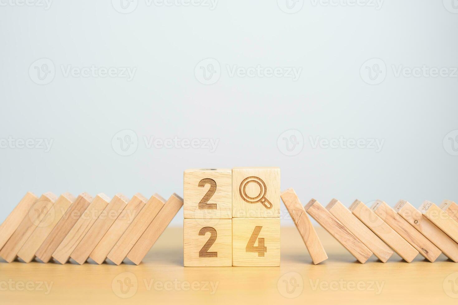 2024 year and falling blocks with magnifying glass icon. SEO, Search Engine Optimization, hiring , Advertising, Risk Management, recession, goal, New Year planning and inflation economy concepts photo