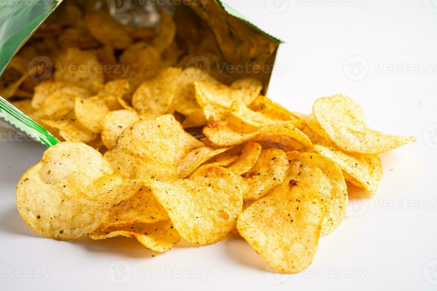 Potato chips, delicious spicy for crips, thin slice deep fried snack fast food in open bag. photo