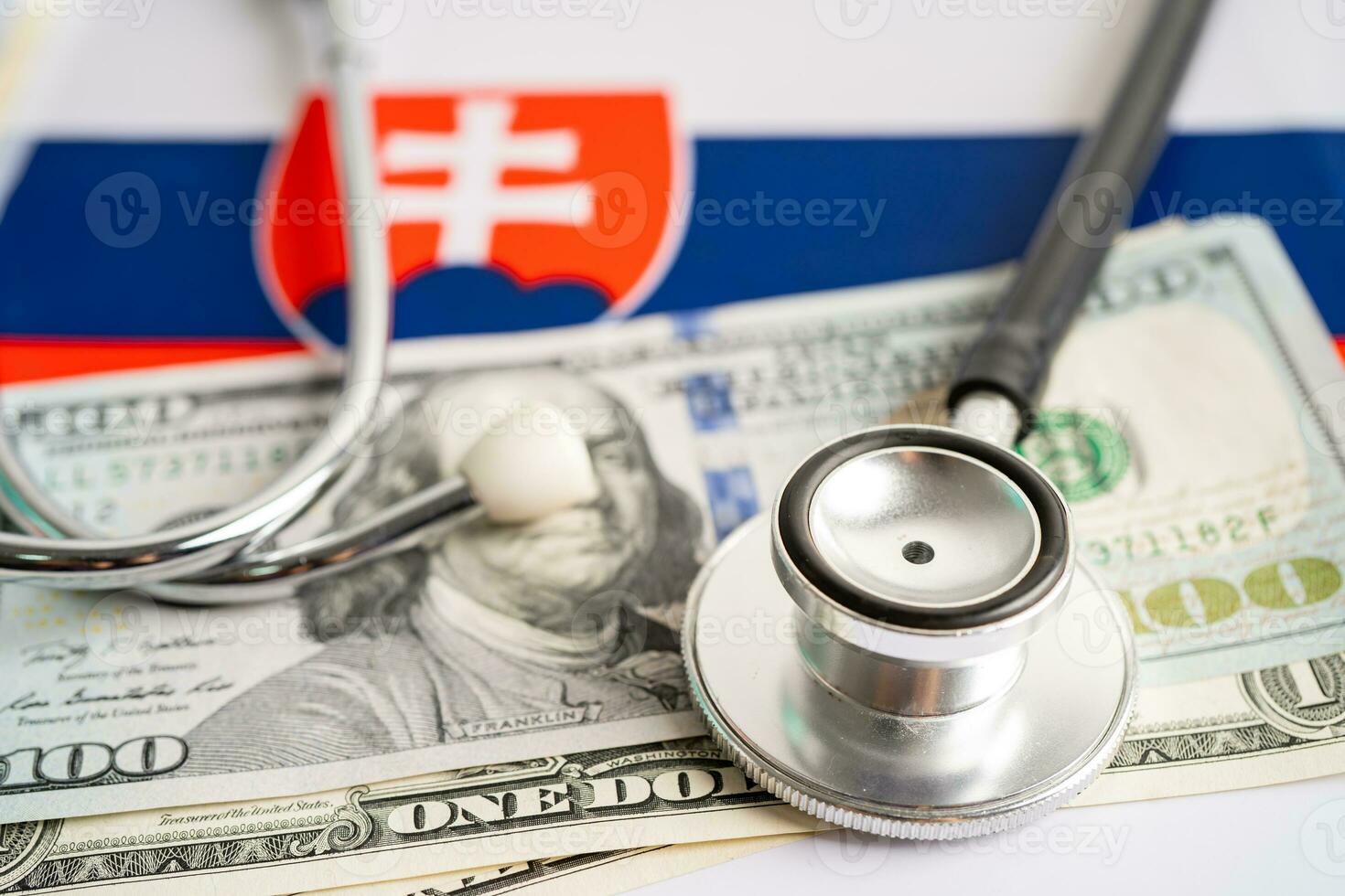 Black stethoscope with US dollar banknotes Slovakia flag background, Business and finance concept. photo