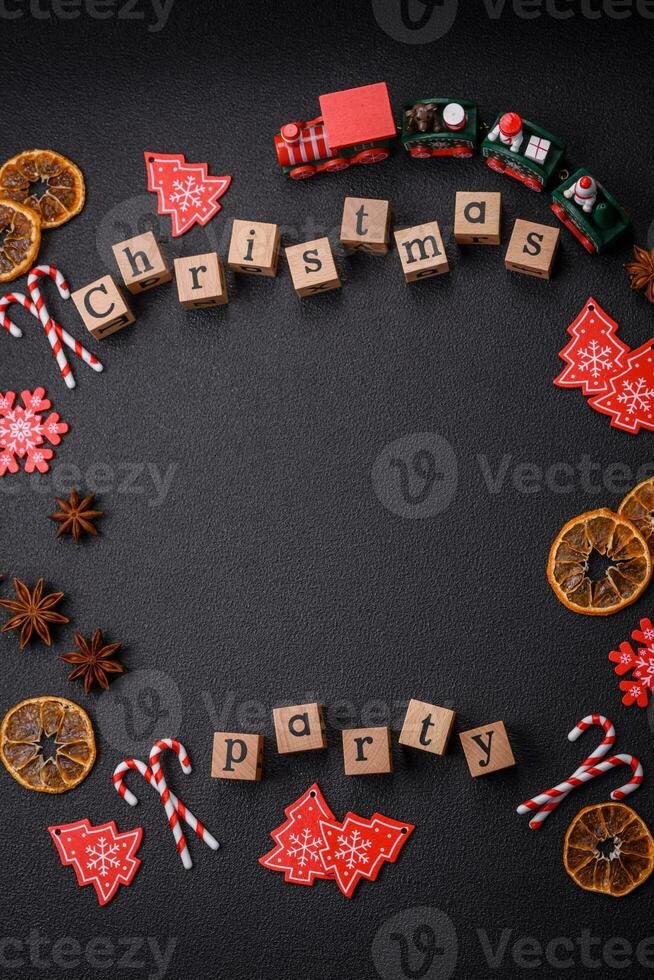 Christmas party inscription with wooden cubes on a dark concrete background photo