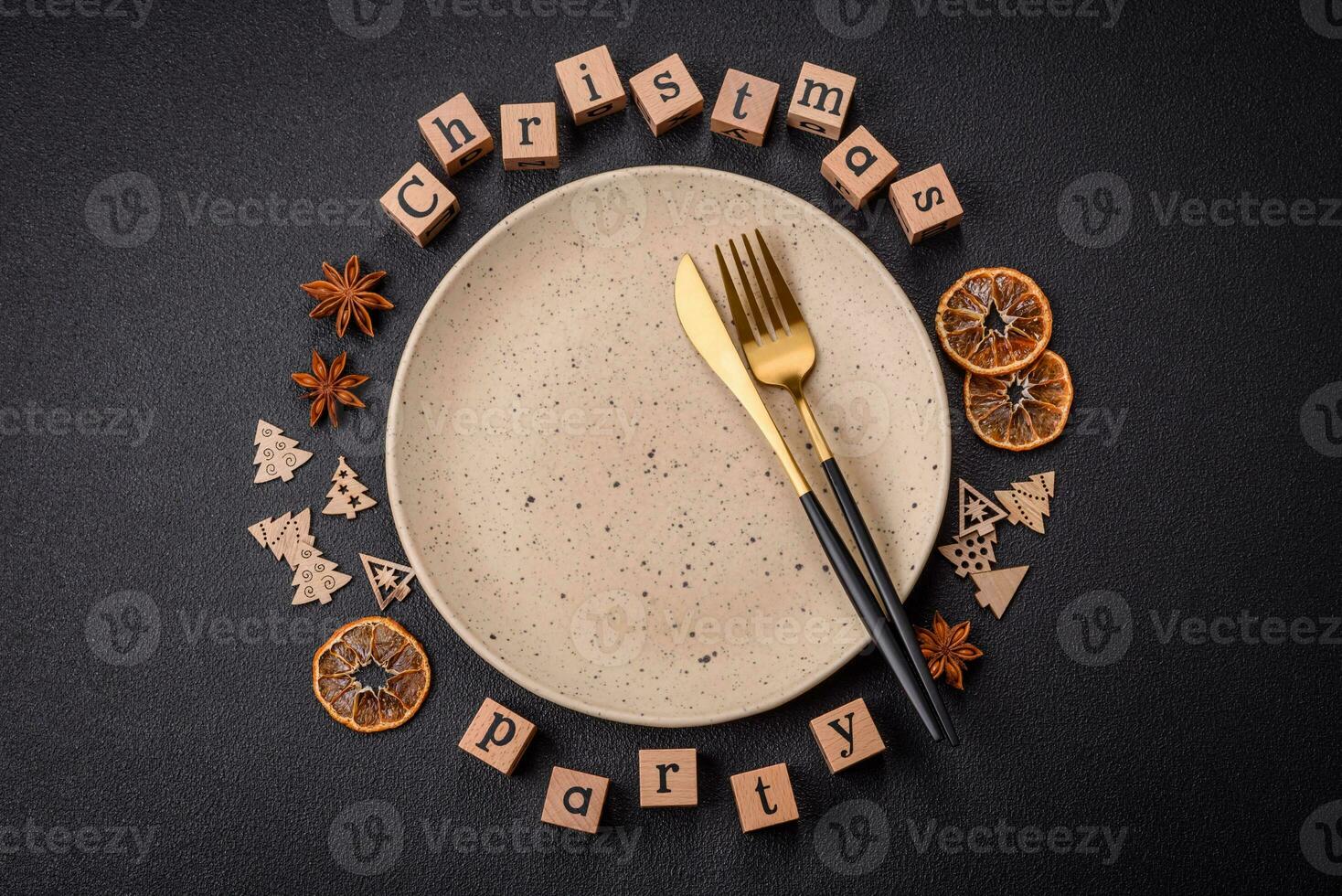 Christmas party inscription with wooden cubes on a dark concrete background photo