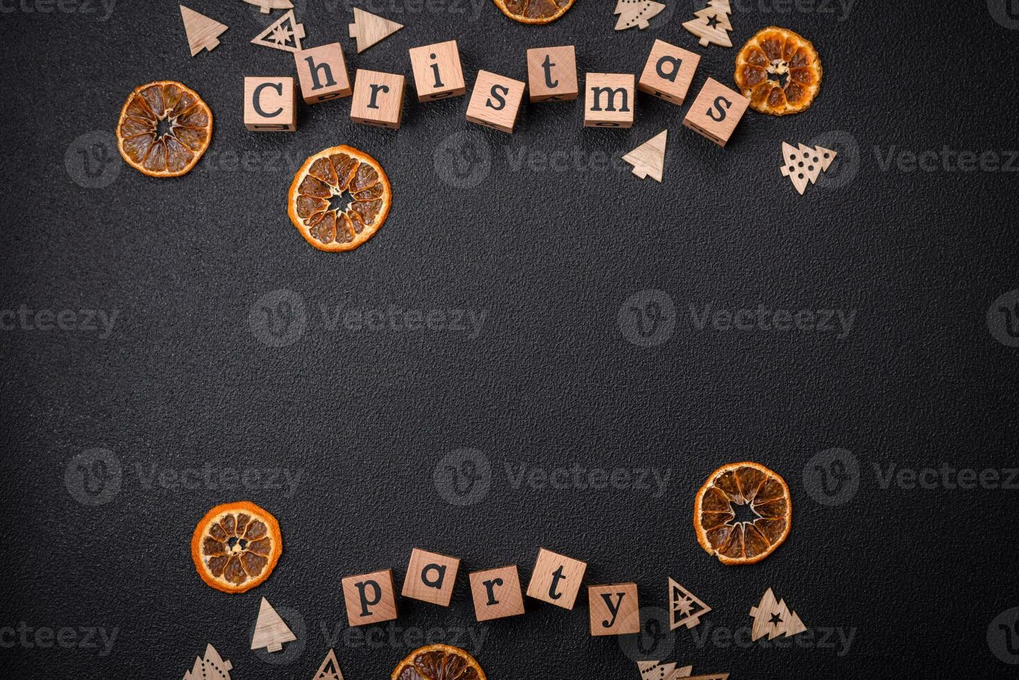 Christmas party inscription with wooden cubes on a dark concrete background photo
