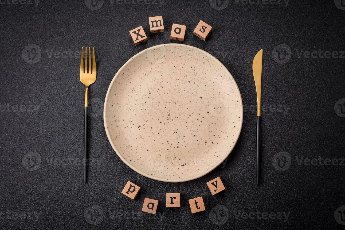 Christmas party inscription with wooden cubes on a dark concrete background photo