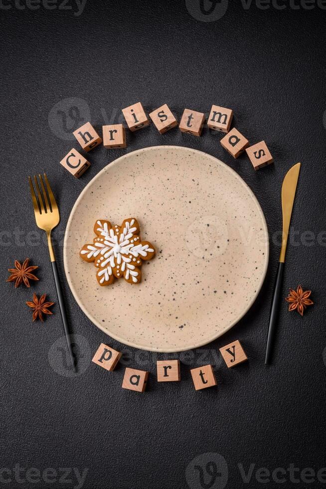 Christmas party inscription with wooden cubes on a dark concrete background photo