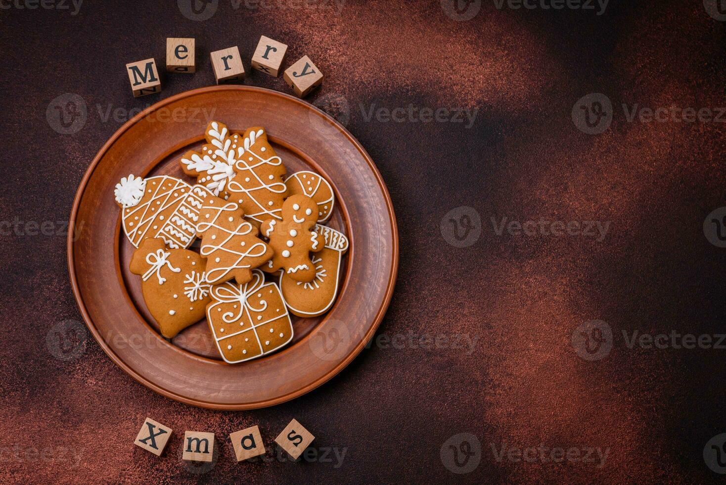 Beautiful delicious sweet winter Christmas gingerbread cookies on a bronze textured background photo
